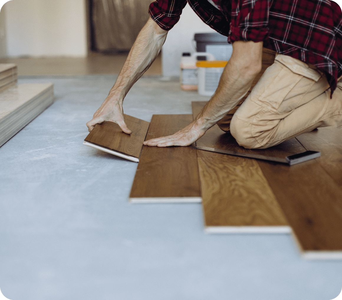Person fitting hardwood planks